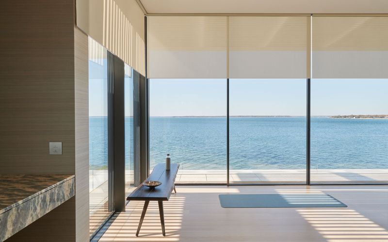 Control4 Touch panel in a able with a traditional home in the background