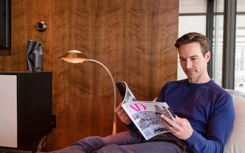 Control4 Touch panel in a able with a traditional home in the background